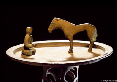 Round tray on conical stand with figures of seated man and standing horse in center. Issyk, Smirechye/Zhetisu (Almaty regiion), 5-3rd c. BCE. Central State Museum, Almaty