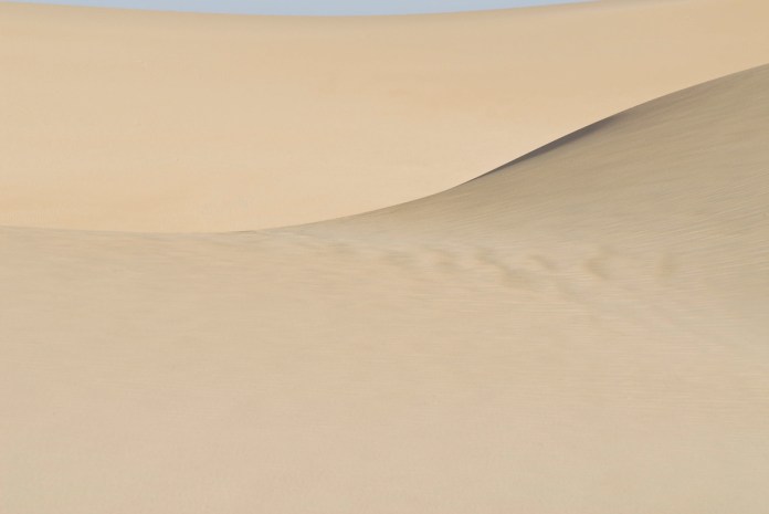 Large sand dune in Saudi Arabia illustrating the effects of wind on sand dunes.